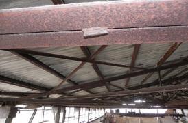 Metal girders painting in manufacture building 